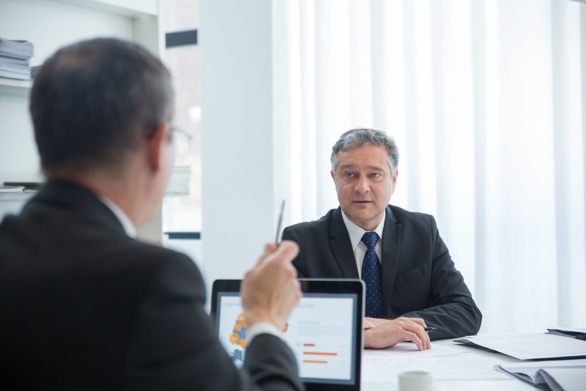 Business professionals in a focused discussion during an office meeting.