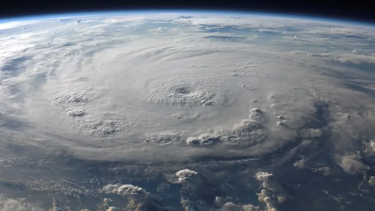 A stunning aerial view of Earth with a massive swirling hurricane, highlighting meteorological beauty.