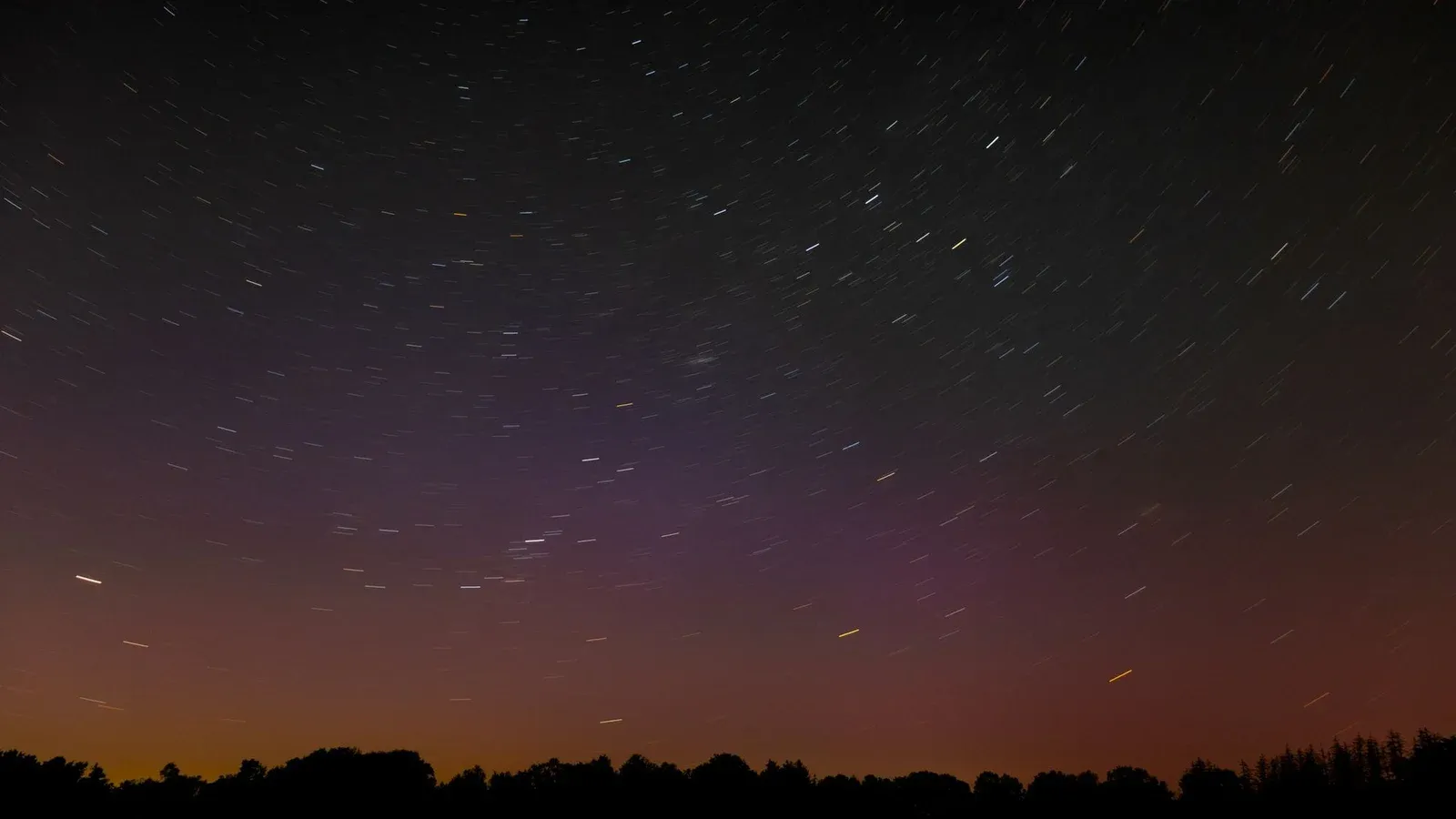 Long exposure of star trails in the night sky above rural Hamburg, Germany.