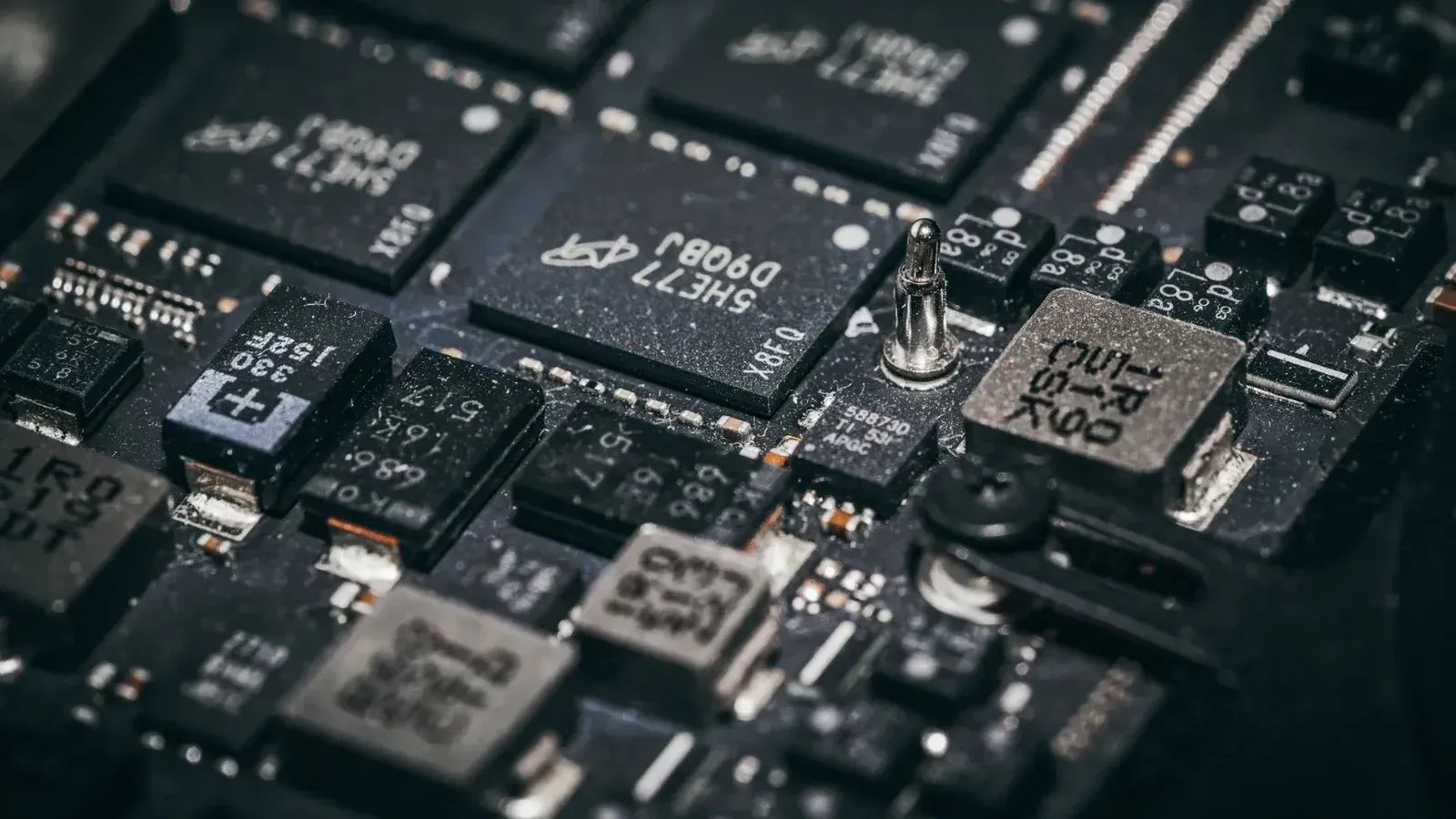 Detailed close-up of electronic microchips on a circuit board, showcasing technology and engineering intricacies.