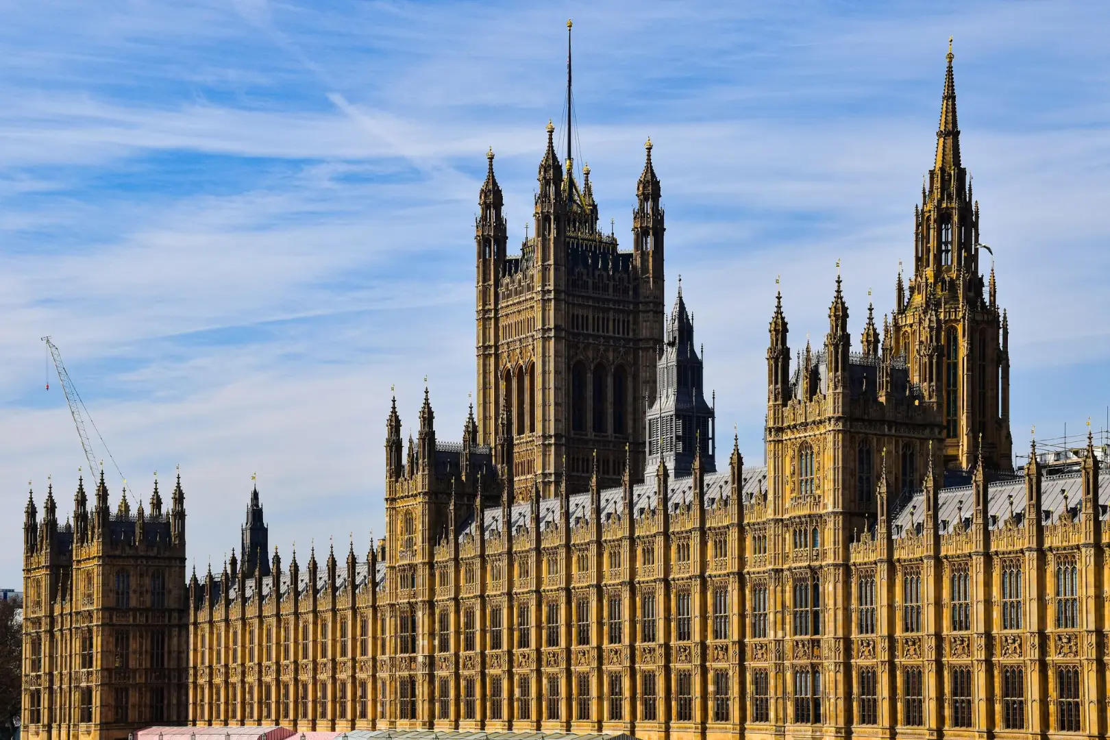 Stunning view of the historic Palace of Westminster in London under a clear blue sky.