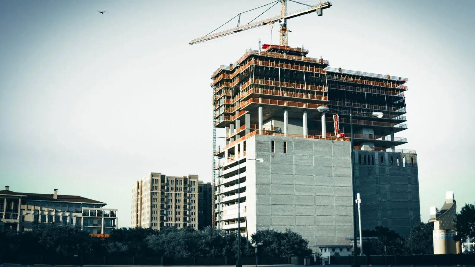 A modern high-rise building under construction in urban Houston, Texas.
