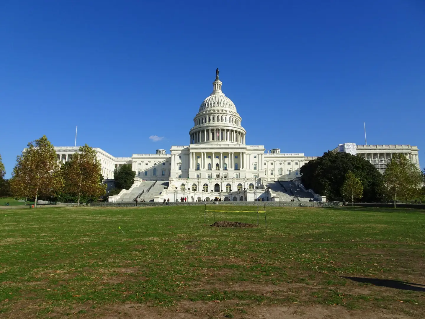 The iconic United States Capitol Building in Washington, D.C., under a clear blue sky.