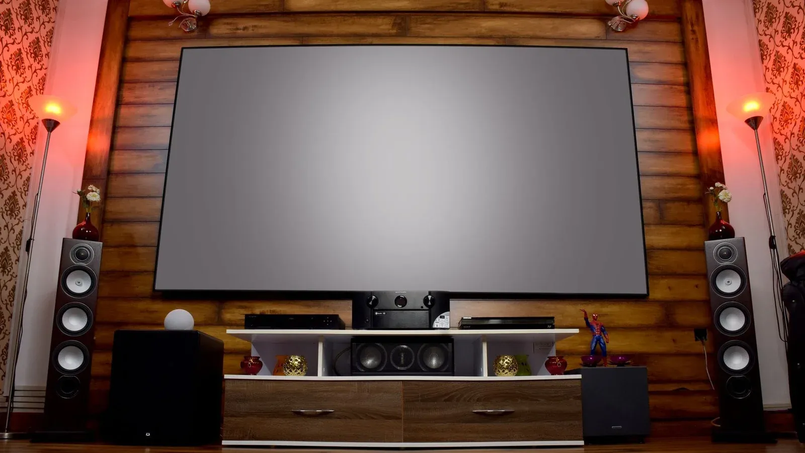 Stylish home theater featuring large screen, audio system, and decor, perfect for entertainment.