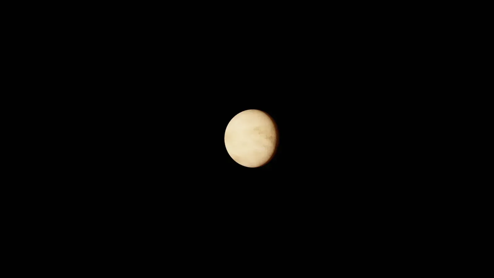 Image of planet Venus against a black space background, highlighting its atmospheric details.