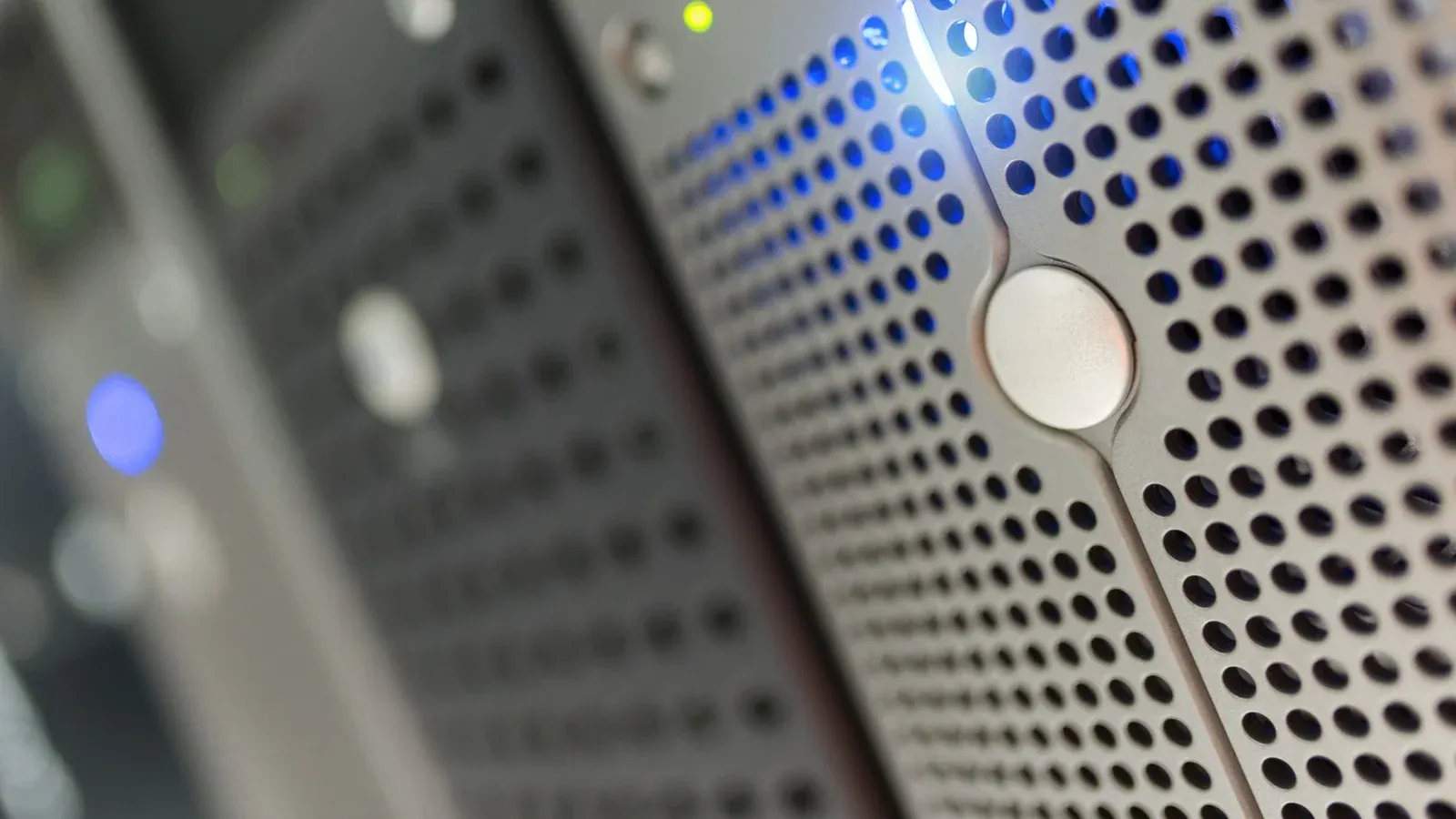 Focused detail of a modern server rack with blue LED indicators in a data center.