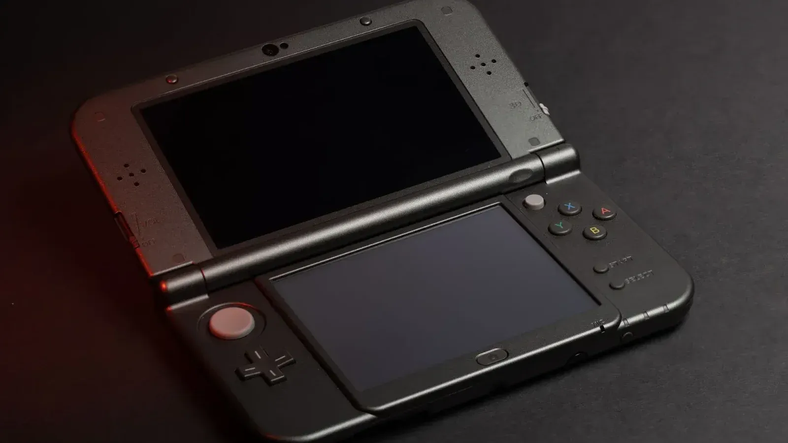 Detailed photo of a Nintendo 3DS console with dual screens and buttons, perfect for gaming enthusiasts.