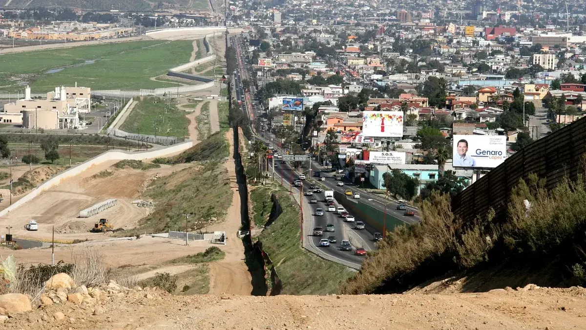 A small fence separates densely-populated Tijuana, Mexico, right, from the United States in the Border Patrol's San Diego Sector.