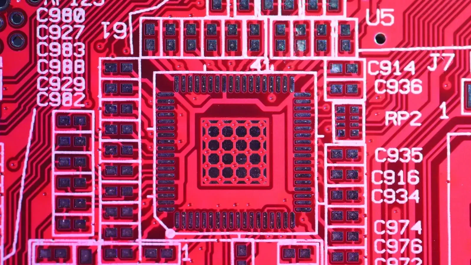 Top view of colorful printed board with bright electric circuits of modern technical machine with various figures and letters on surface
