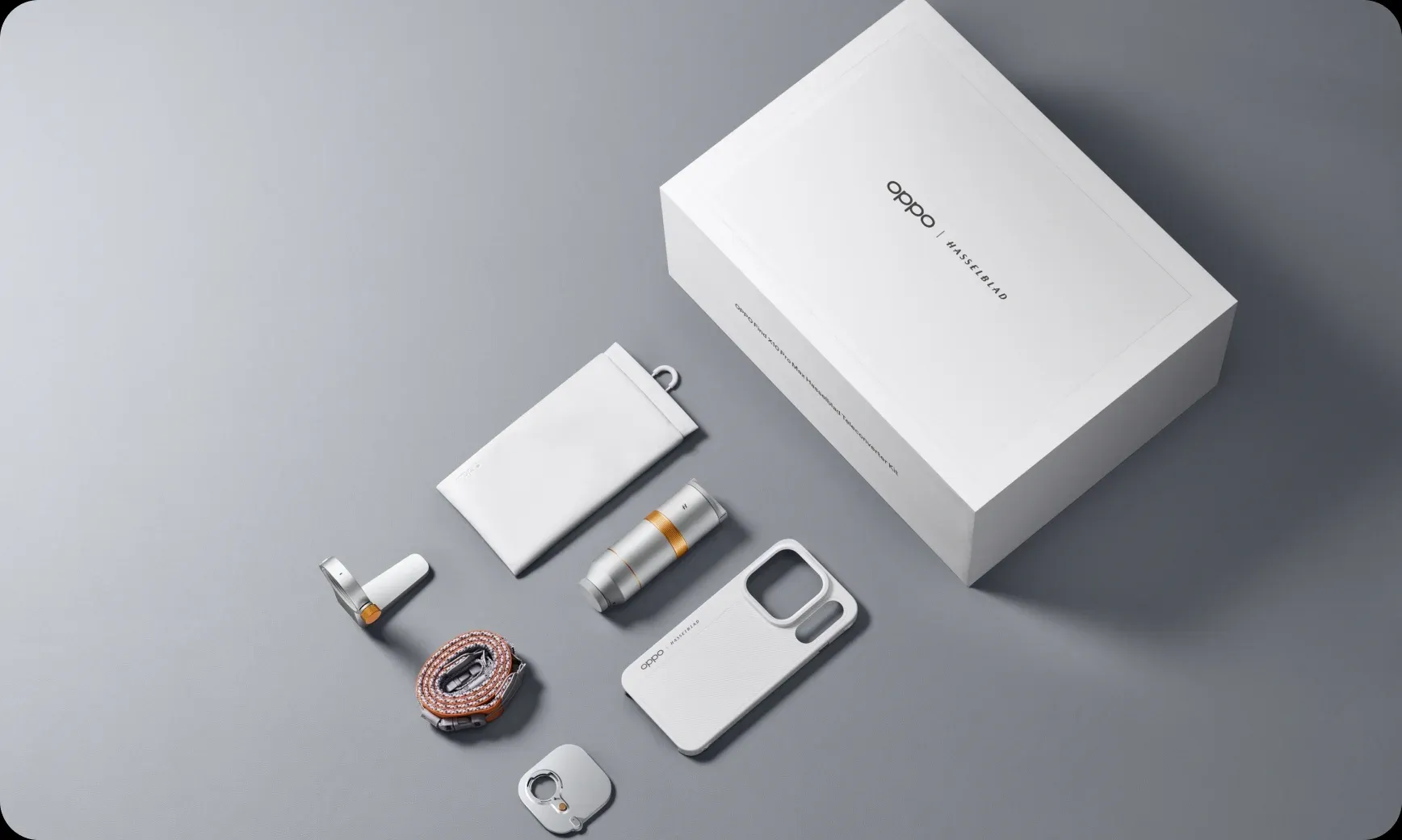 Flat lay display of the OPPO Hasselblad Teleconverter Kit with lens, case, strap, and box