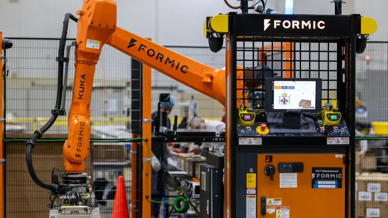 Formic F50 industrial palletizer running on a customer line | Formic-branded KUKA arm with operator station