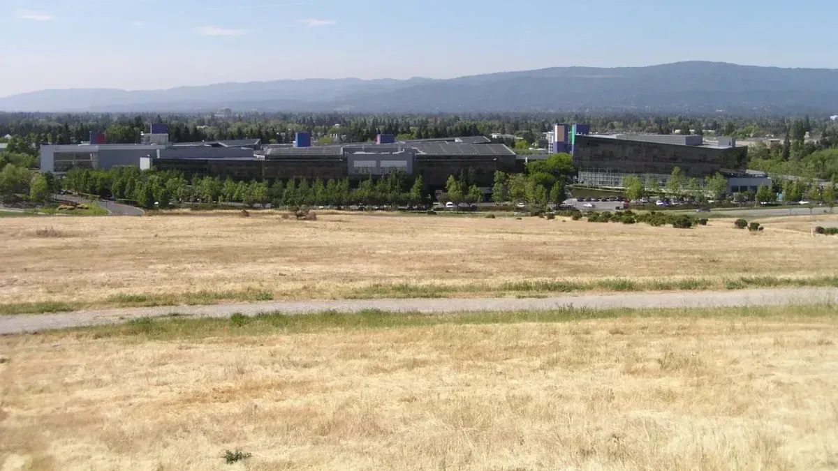 A photo of Google corporate headquarters, taken from across the street looking West.