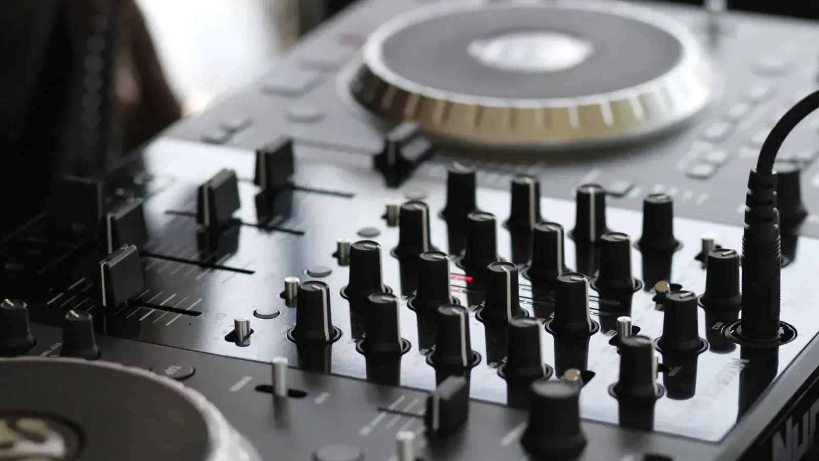 Detailed view of a professional audio mixing console with knobs and controls for sound engineering.