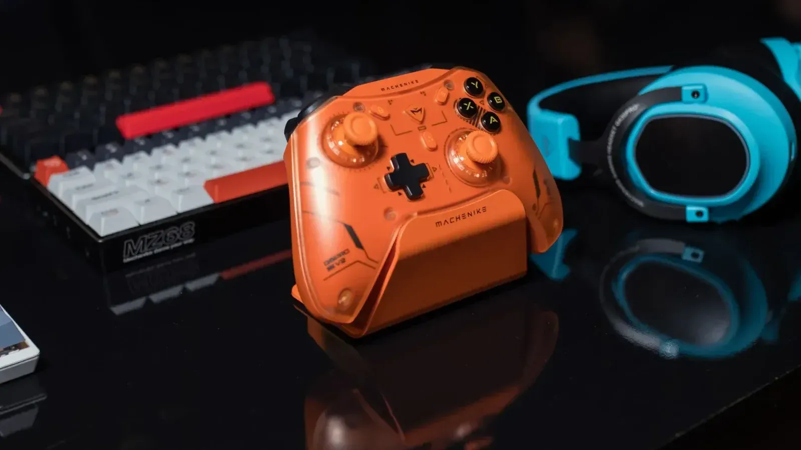 Dynamic gaming setup featuring an orange controller, keyboard, and blue headset.