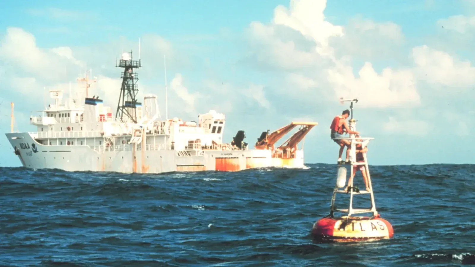 The National Oceanic and Atmospheric Administration oceanographic research ship NOAAS Kaimimoana (R 333) services an Atlas buoy in the equatorial Pacific Ocean.