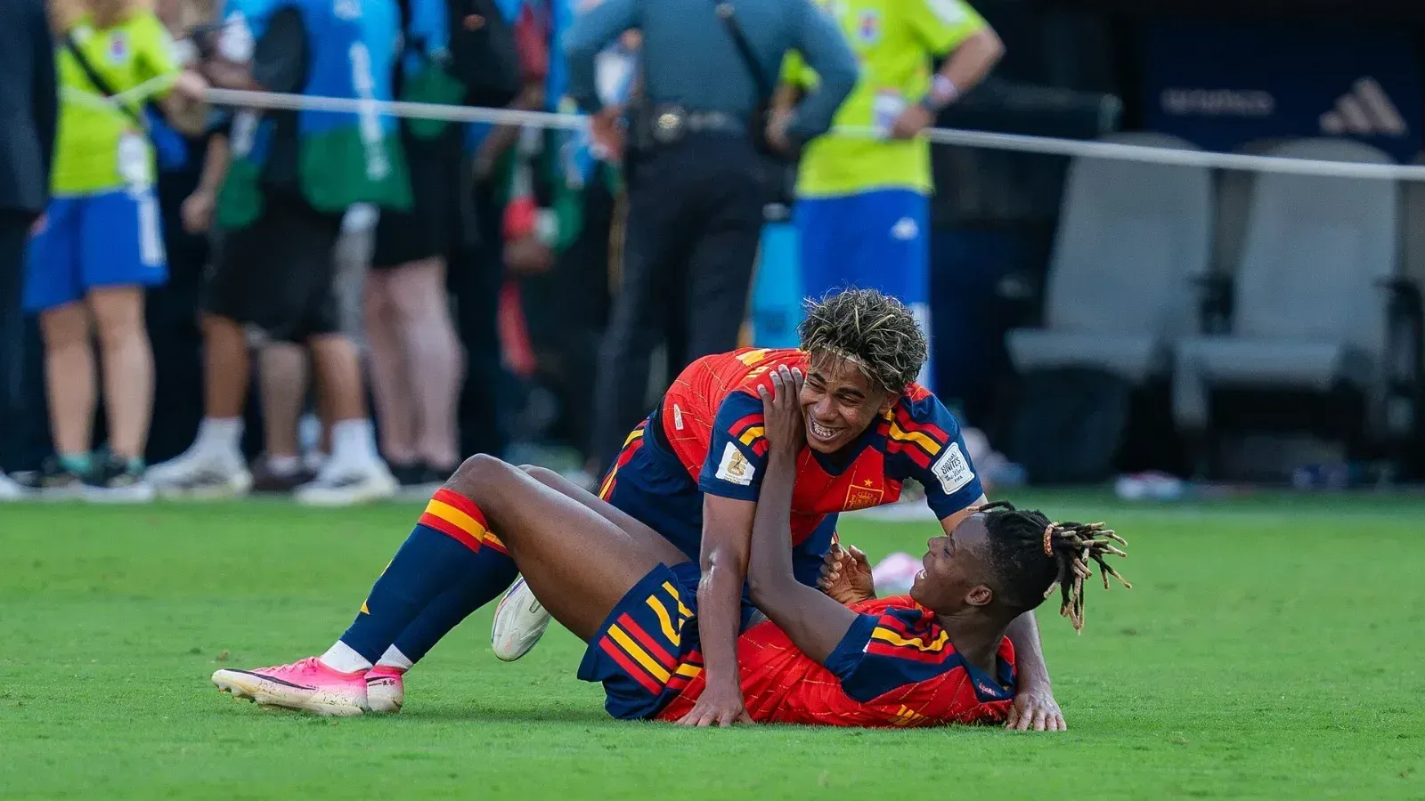 Lamine Yamal, sonriente, sobre Nico Williams, tendido en el césped, ambos con la camiseta roja de España en la final del Mundial 2026