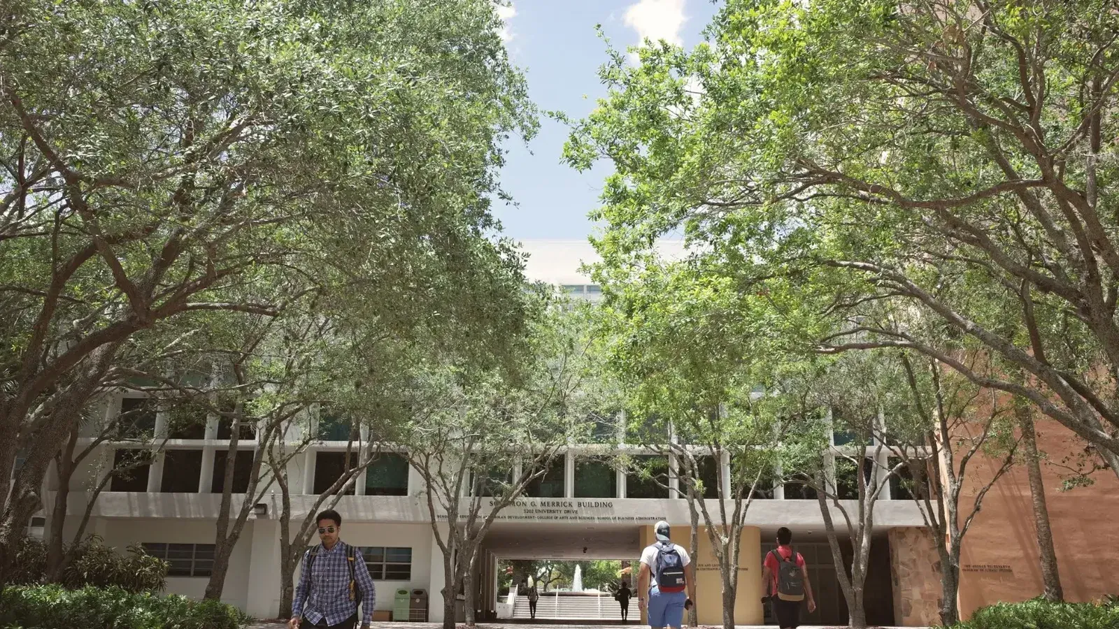 Students walking through a sunlit university campus in Coral Gables, Florida.