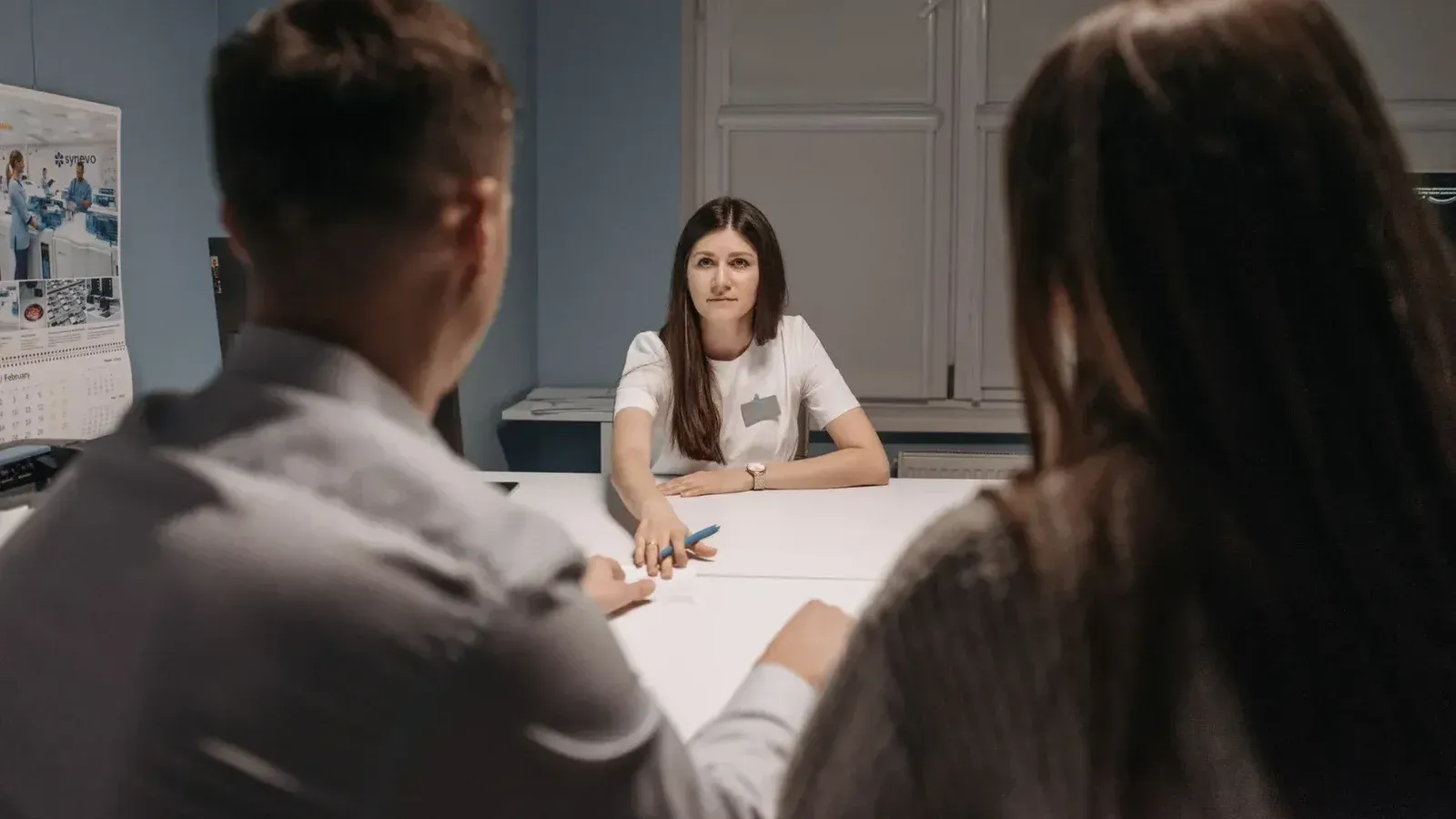 Professional meeting in a healthcare office setting with medical staff discussion.