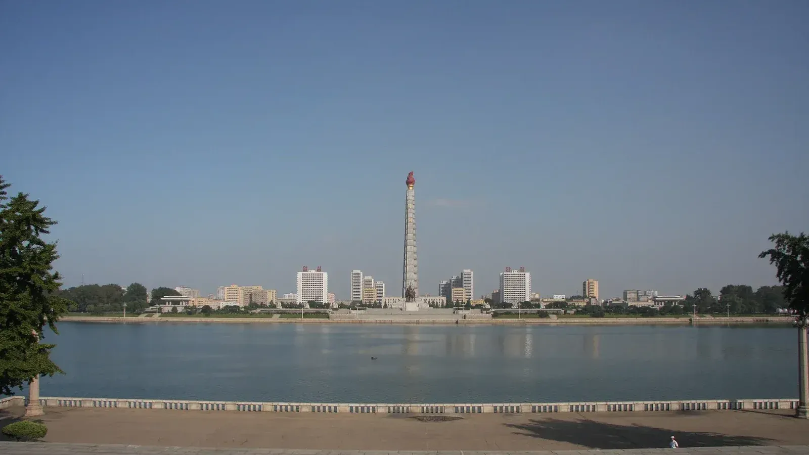 View from the Kim Il-Sung Square over Taedong River towards the Juche Tower, Pyongyang.