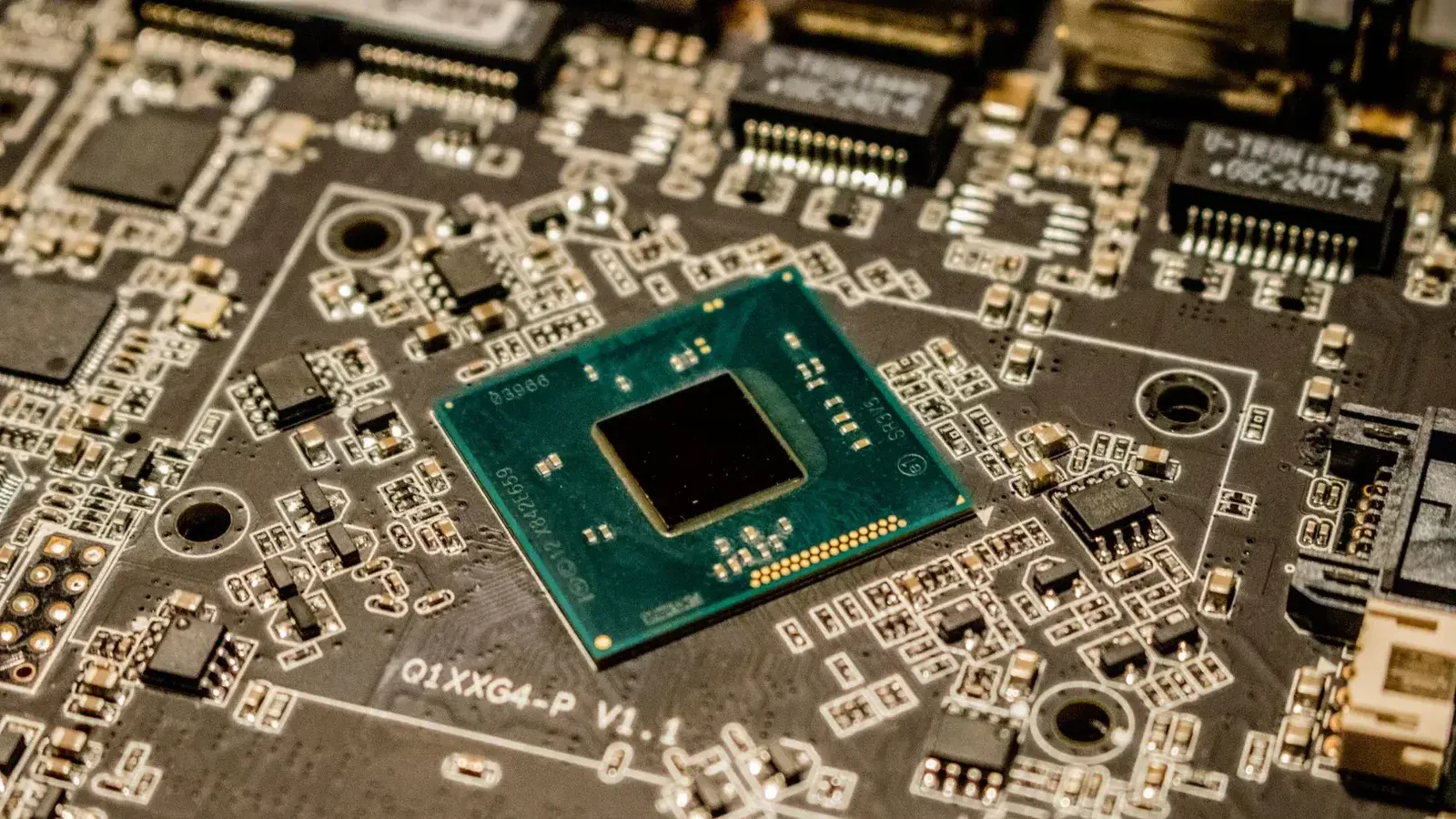 Detailed view of a microchip on a printed circuit board, showcasing electronic components.