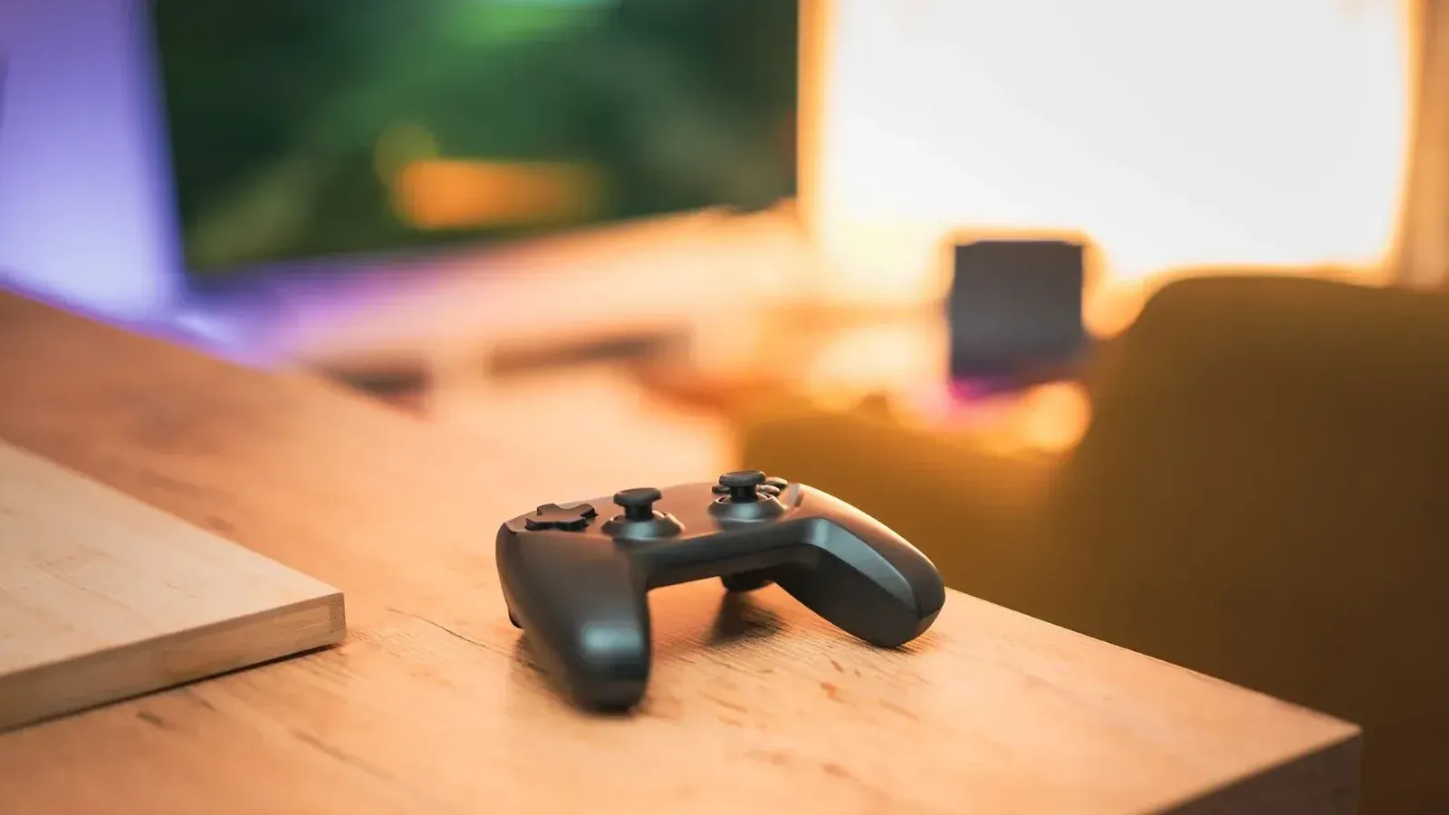 A cozy indoor scene with a video game controller on a desk, perfect for gaming enthusiasts.