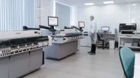 Scientist in a modern laboratory analyzing data on advanced equipment and monitors.