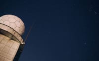 A stunning view of a starry night sky above an observatory dome, capturing the beauty of the cosmos.