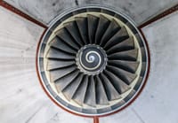 Detailed overhead view of industrial jet engine turbine blades showcasing intricate patterns.