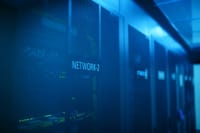 A modern server room featuring network equipment with blue illumination. Ideal for technology themes.