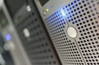 Focused detail of a modern server rack with blue LED indicators in a data center.