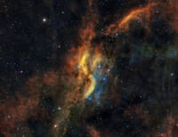 Dynamic scene of colorful gas clouds and stars in a cosmic nebula.