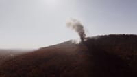 Smoke billowing from a fire on a scenic mountain in Chattanooga, Tennessee.