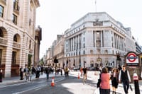 Lively scene at Bank Station, London. Classic architecture meets urban life.