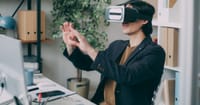 A man in an office environment using a virtual reality headset, engaging with VR content.
