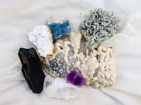 Diverse mineral specimens including amethyst and quartz on display.