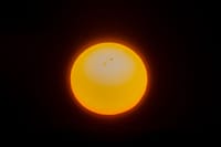 Close-up view of the sun showcasing solar flares and sunspots, captured in a cosmic setting.