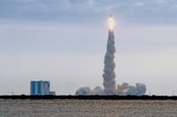 Dramatic view of a rocket launching from Kennedy Space Center in Florida with a trail of smoke.