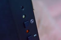Detailed close-up of buttons on a black electronic device with control indicators.