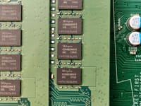 Detailed view of a green circuit board with SK hynix chips, showcasing electronic components.