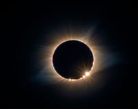 A breathtaking solar eclipse displaying the Baily's Beads effect and solar corona.