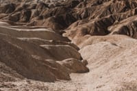 A captivating view of rugged, dry terrain in Death Valley's desert landscape.