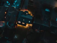 Drone view of roof of traditional houses located in city residential district in evening