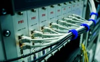 Close-up of ethernet cables connected to a network switch panel in a data center.