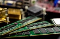 Detailed view of RAM sticks and microprocessors on a motherboard.