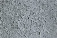 Detailed close-up of a textured concrete surface with visible cracks.
