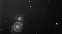 A captivating black and white image of a spiral galaxy in the expansive cosmos.