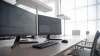 Stylish contemporary office featuring multiple computer monitors and ergonomic chairs.