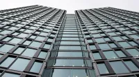 Low angle view of a modern office building with glass facade in Warsaw, Poland.