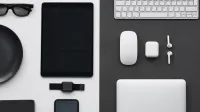Stylish flatlay of modern tech gadgets including tablet, smartphone, smartwatch, and accessories.
