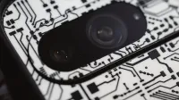 Macro shot of an electronic circuit design around a smartphone camera lens, showing intricate details.